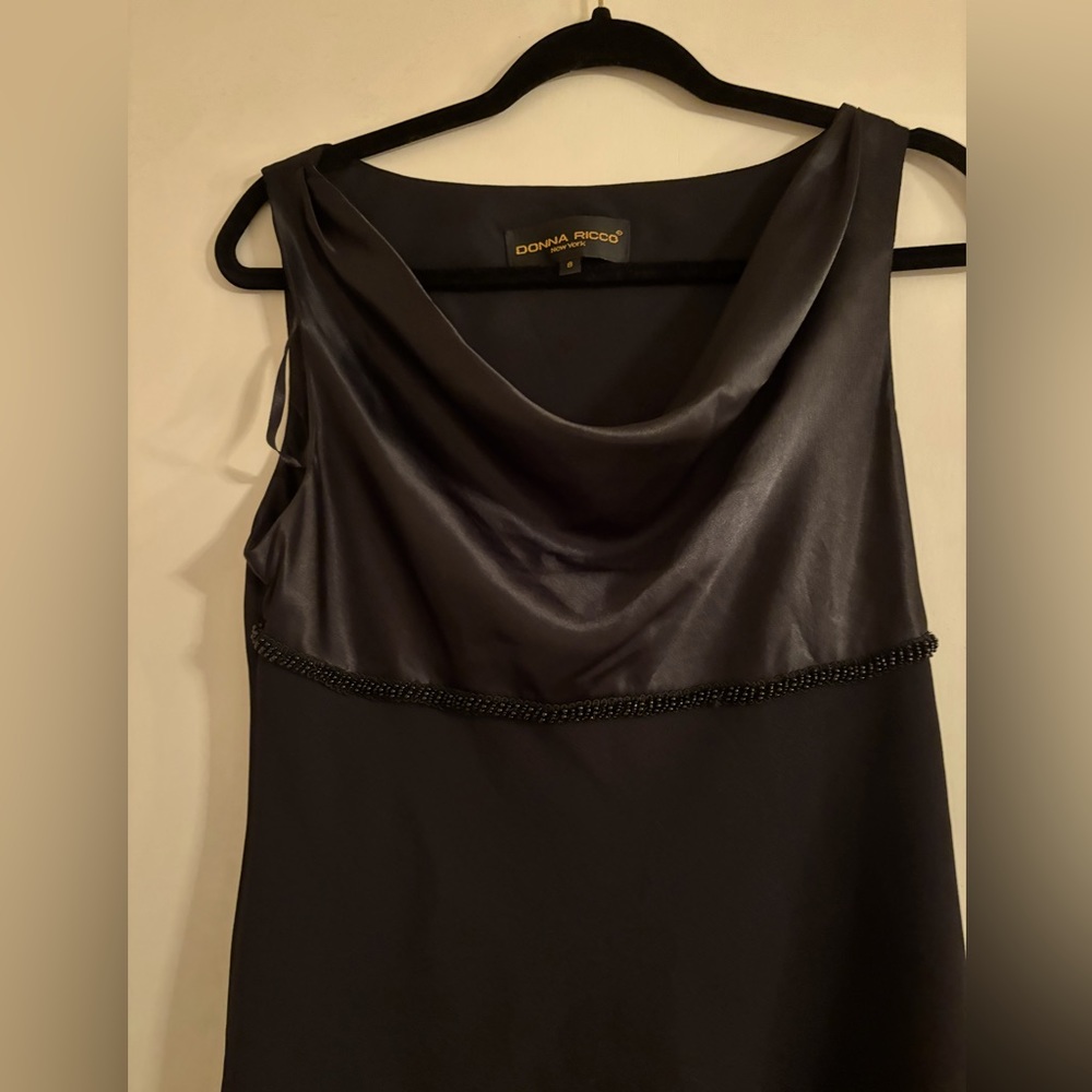 Dressy, black, sleeveless, cowl neck dress.